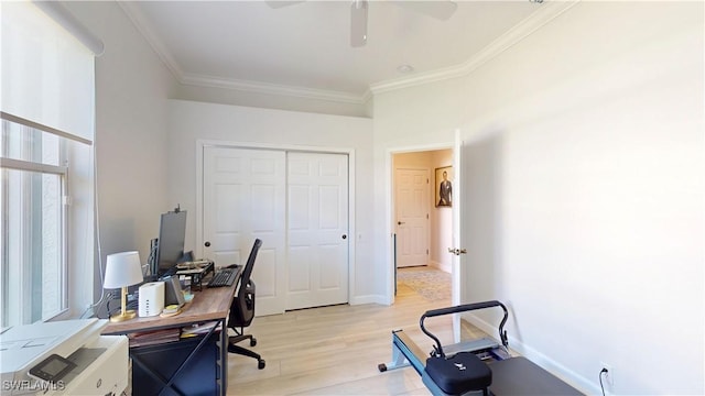 office area featuring light wood-style floors, baseboards, ornamental molding, and a ceiling fan