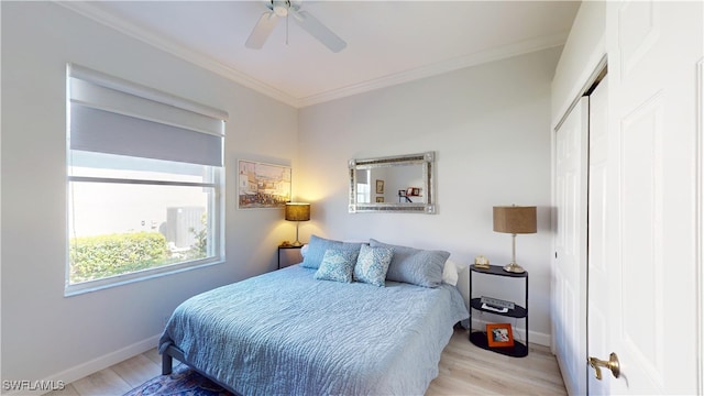 bedroom with light wood finished floors, baseboards, and ornamental molding