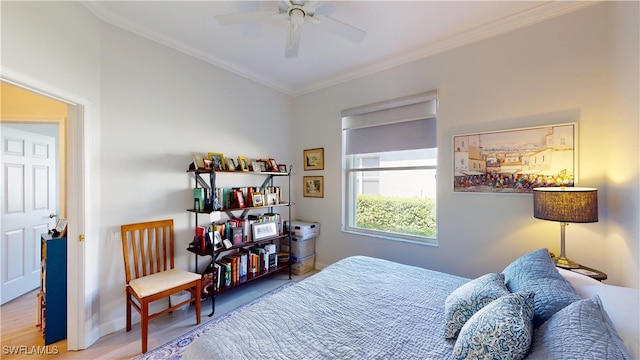 bedroom with baseboards, wood finished floors, a ceiling fan, and crown molding