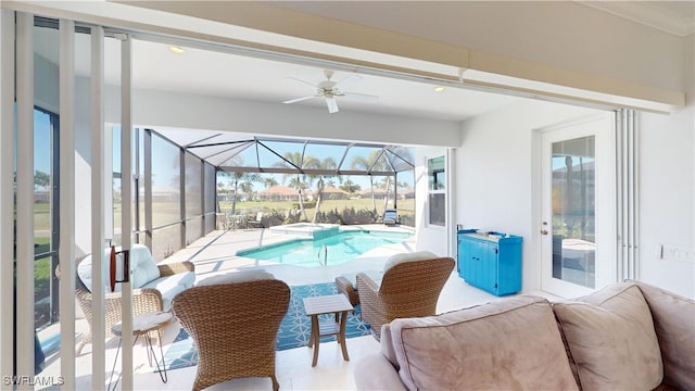 view of pool with a ceiling fan and a pool with connected hot tub