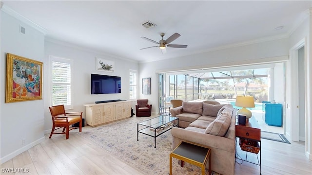 living room with light wood finished floors, visible vents, and crown molding