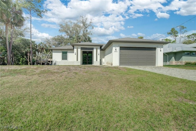 view of front of home with a front yard and a garage