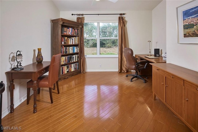 office space with light wood-type flooring and baseboards