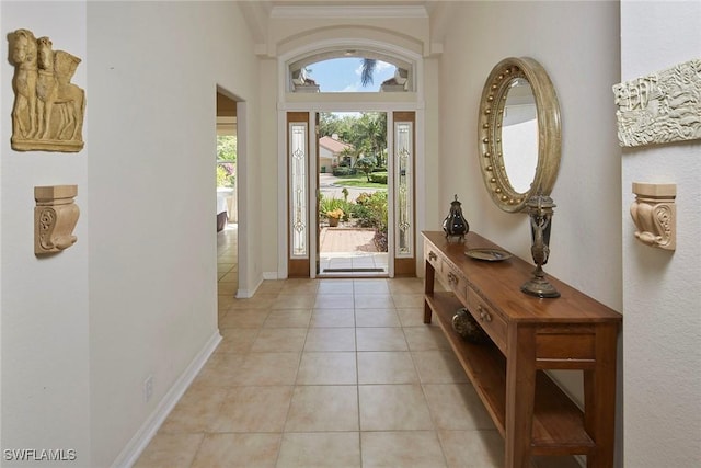 entrance foyer featuring baseboards and light tile patterned floors