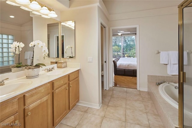 ensuite bathroom featuring tile patterned flooring, double vanity, connected bathroom, and a sink