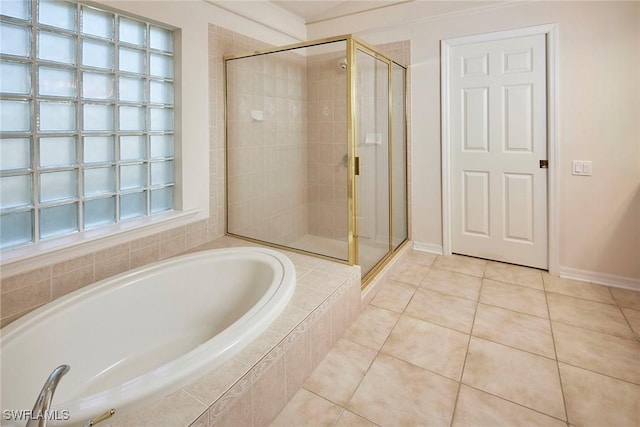 full bathroom with a stall shower, a garden tub, and tile patterned flooring