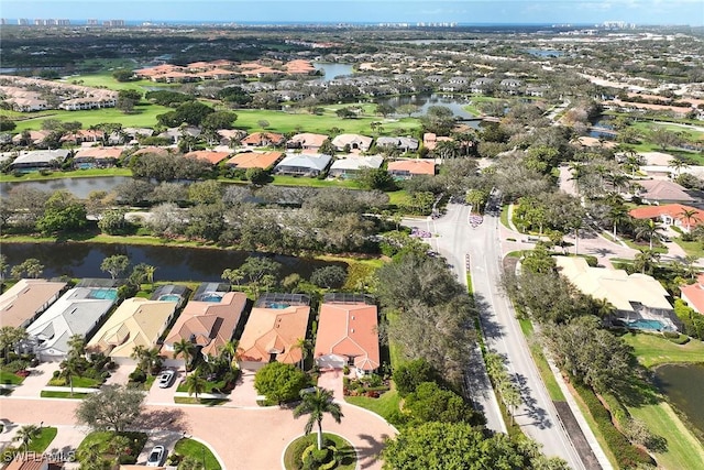 drone / aerial view with a water view and a residential view