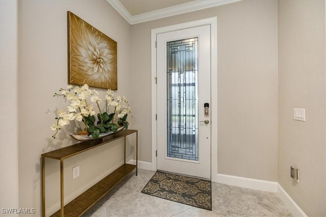 tiled entryway featuring crown molding and baseboards