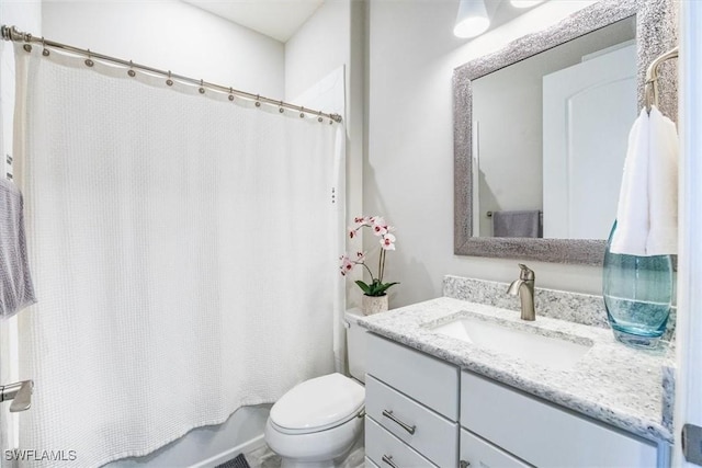 bathroom with shower / bath combination with curtain, vanity, and toilet