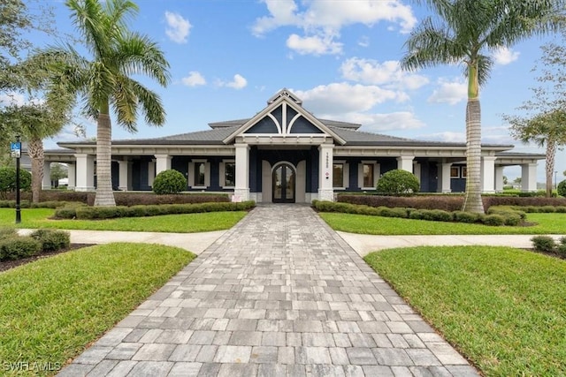 view of front of property featuring a front lawn and french doors