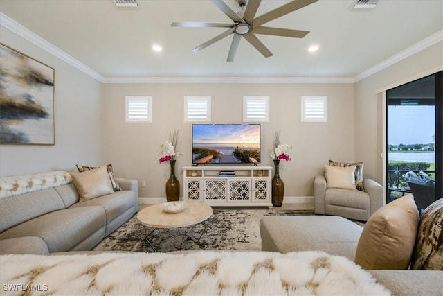 living area with crown molding, baseboards, and a healthy amount of sunlight