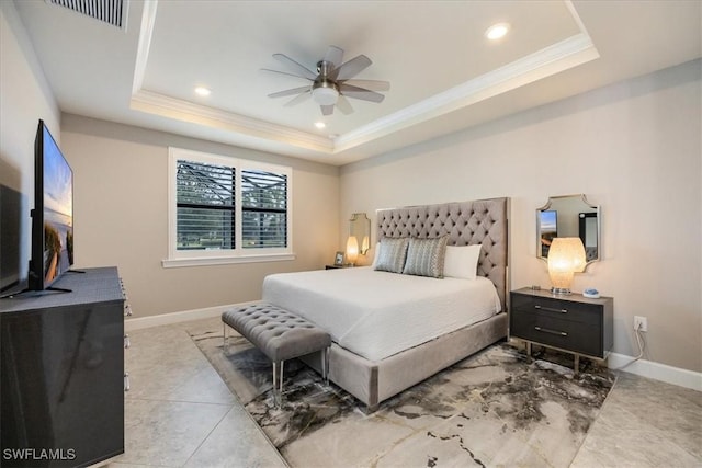 bedroom featuring a tray ceiling, visible vents, crown molding, and baseboards