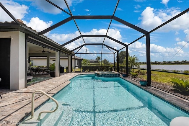 view of swimming pool with ceiling fan, a patio, glass enclosure, a water view, and a pool with connected hot tub