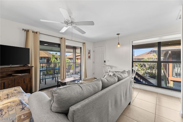1811 Olde Middle Gulf Dr Unit 10, Sanibel, FL 33957 - living area featuring light tile patterned floors, a ceiling fan, and a wealth of natural light