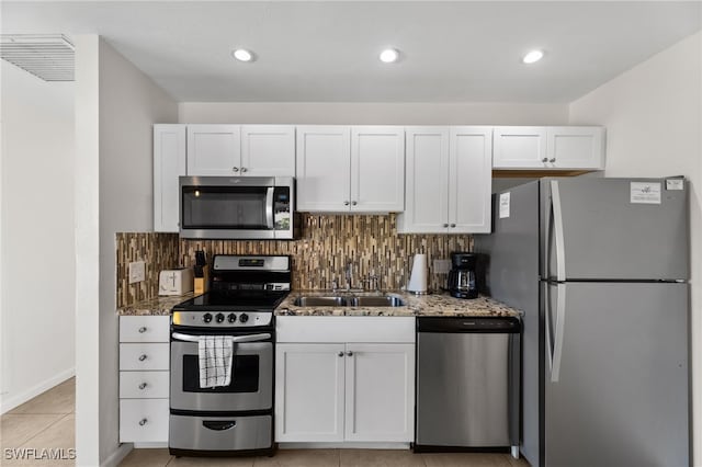 1811 Olde Middle Gulf Dr Unit 10, Sanibel, FL 33957 - kitchen featuring light stone counters, stainless steel appliances, visible vents, backsplash, and a sink