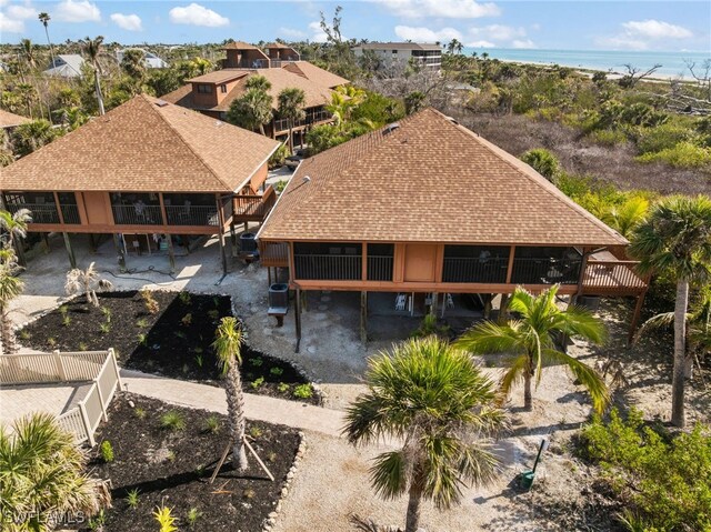 1811 Olde Middle Gulf Dr Unit 10, Sanibel, FL 33957 - rear view of house with a water view, a patio area, and fence