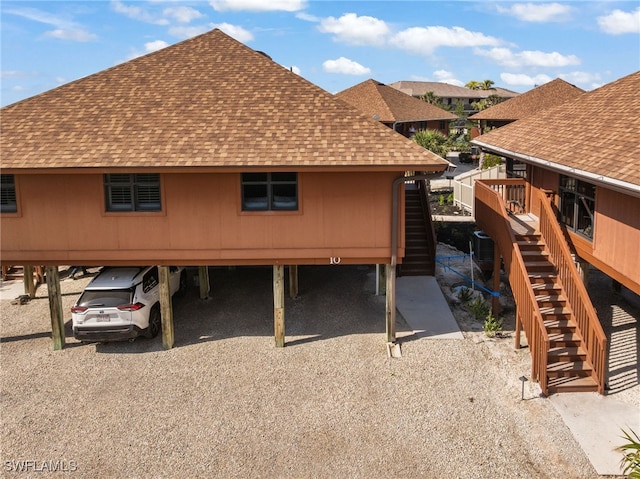 1811 Olde Middle Gulf Dr Unit 10, Sanibel, FL 33957 - exterior space featuring a carport, roof with shingles, and stairway