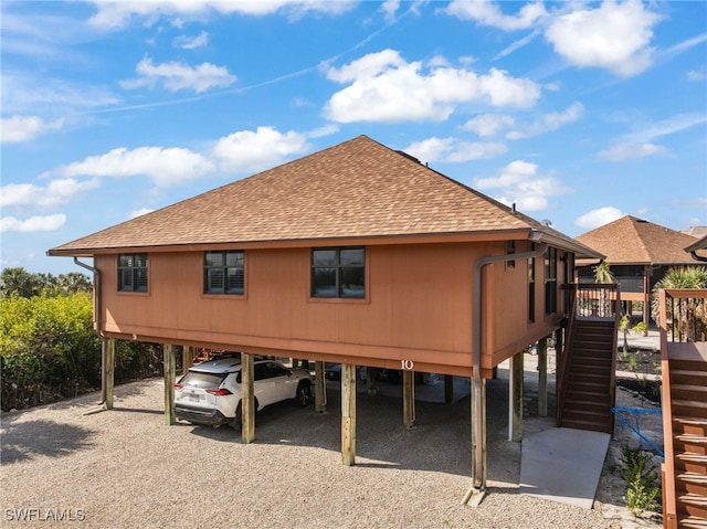 1811 Olde Middle Gulf Dr Unit 10, Sanibel, FL 33957 - exterior space with stairs, a carport, a shingled roof, and driveway