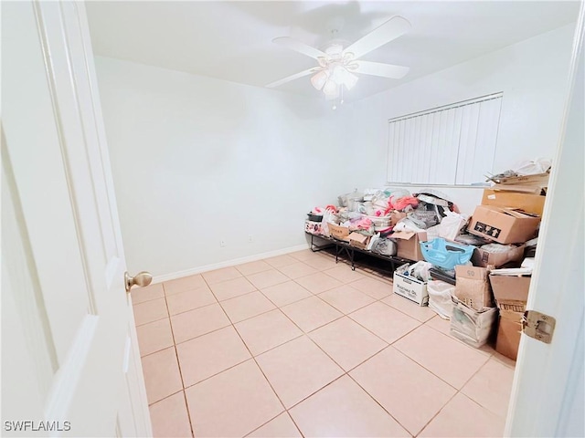 bedroom with a ceiling fan, baseboards, and light tile patterned floors