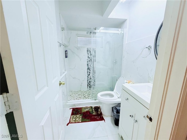 full bath with toilet, a marble finish shower, and vanity