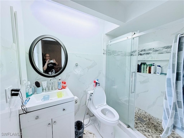 full bathroom with toilet, vanity, tile walls, marble finish floor, and a stall shower