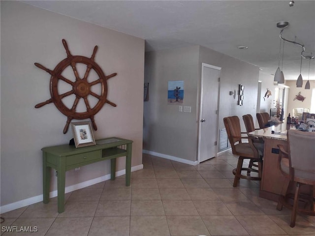 dining space featuring baseboards and light tile patterned floors