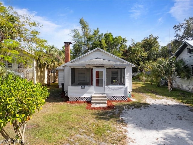 bungalow-style home featuring a front lawn