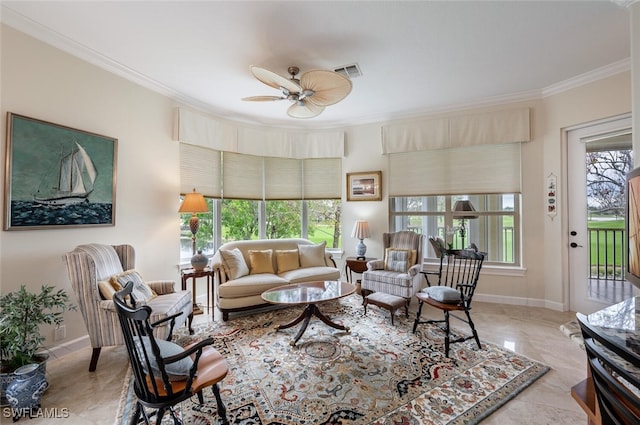 living room featuring ornamental molding, visible vents, ceiling fan, and baseboards