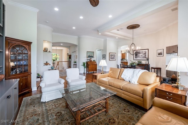 living room featuring arched walkways, recessed lighting, a notable chandelier, dark wood-style flooring, and crown molding