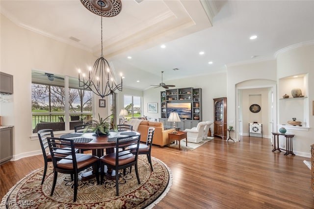 dining room with baseboards, ornamental molding, wood finished floors, and ceiling fan with notable chandelier