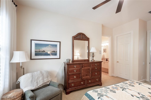 bedroom with ceiling fan, connected bathroom, light carpet, visible vents, and baseboards