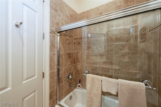 bathroom with bath / shower combo with glass door