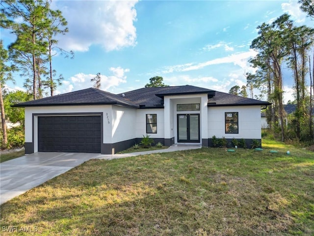 view of front of property featuring a garage and a front yard