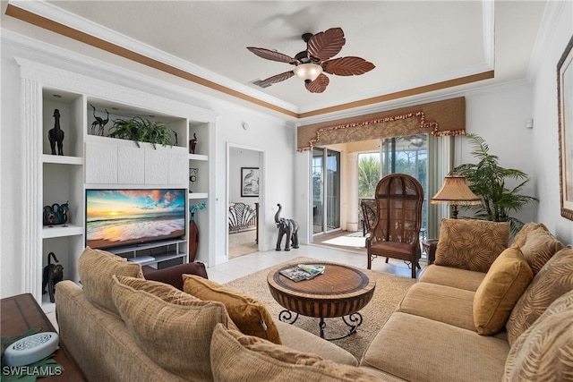 living area featuring crown molding, tile patterned floors, a tray ceiling, and ceiling fan