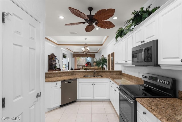 kitchen featuring ornamental molding, a sink, a tray ceiling, stainless steel electric stove, and dishwashing machine