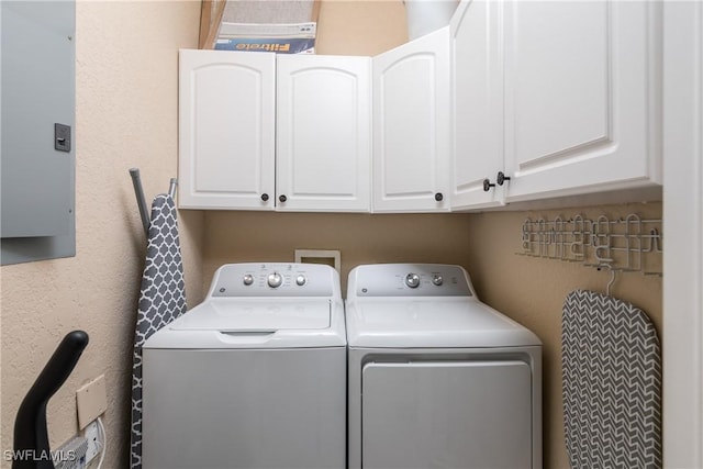 washroom with cabinet space and washer and dryer