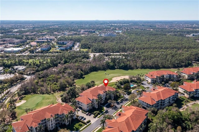 bird's eye view with golf course view and a forest view