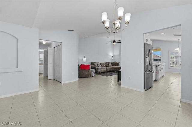 dining area with lofted ceiling, baseboards, ceiling fan with notable chandelier, and light tile patterned flooring