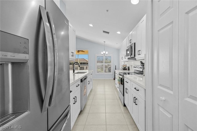 kitchen with light tile patterned floors, stainless steel appliances, a sink, visible vents, and vaulted ceiling