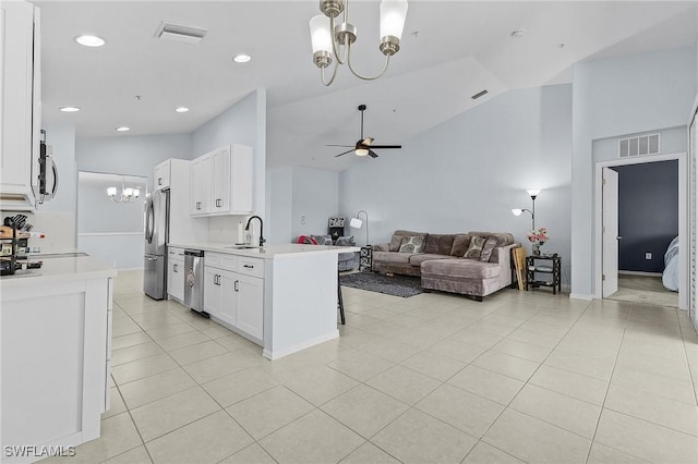 kitchen featuring visible vents, white cabinets, open floor plan, light countertops, and appliances with stainless steel finishes