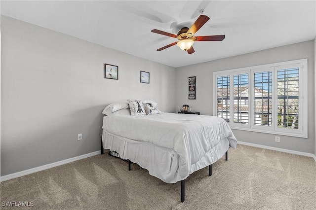 bedroom with a ceiling fan, carpet, and baseboards