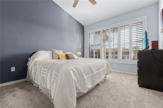 carpeted bedroom with a ceiling fan, lofted ceiling, and baseboards