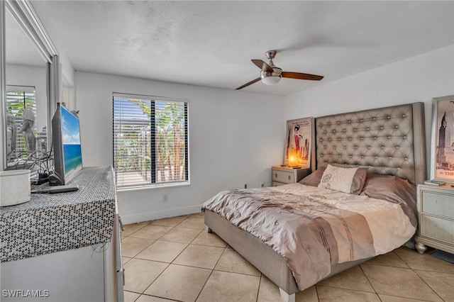 bedroom featuring access to outside, baseboards, a ceiling fan, and light tile patterned flooring