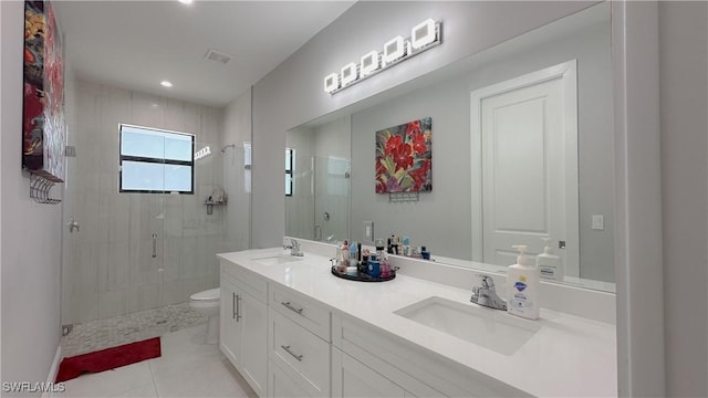 bathroom featuring tile patterned flooring, toilet, a sink, visible vents, and a stall shower