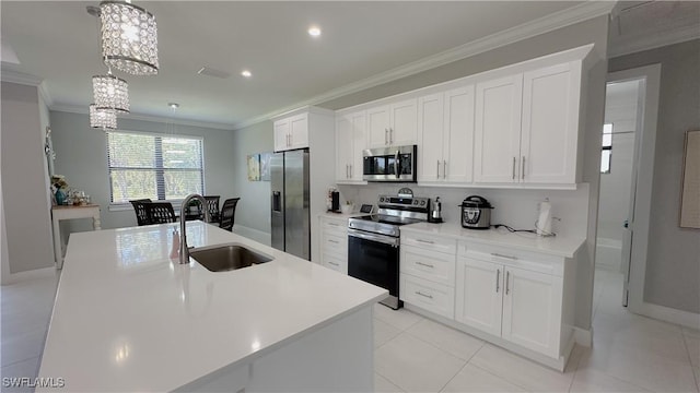 kitchen with appliances with stainless steel finishes, a sink, white cabinetry, and crown molding