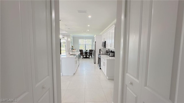 hall featuring visible vents, ornamental molding, light tile patterned flooring, a sink, and recessed lighting