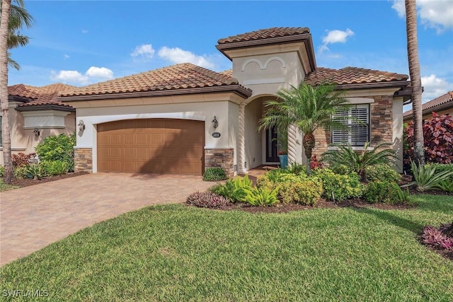 mediterranean / spanish-style house with a garage, a front yard, stone siding, and driveway