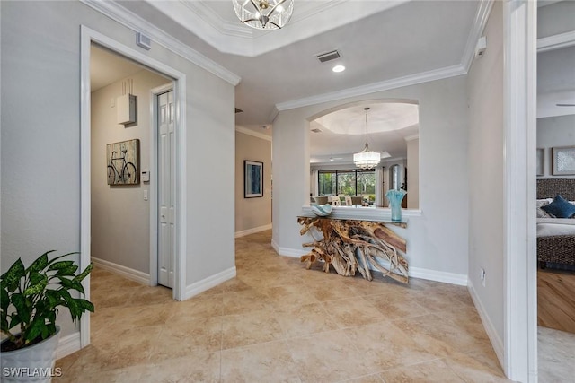 hallway with a chandelier, arched walkways, visible vents, and crown molding