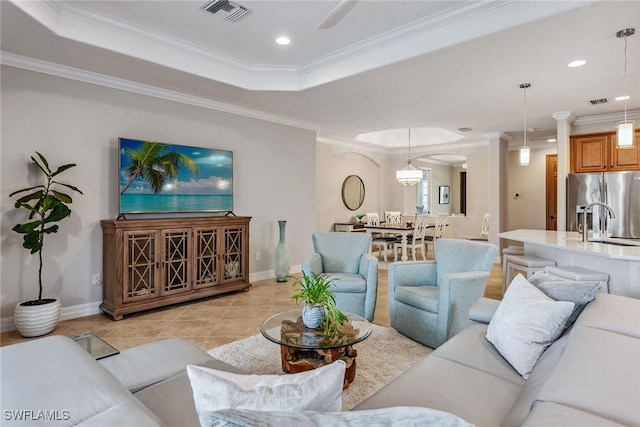 living area featuring a tray ceiling, crown molding, recessed lighting, visible vents, and light tile patterned flooring