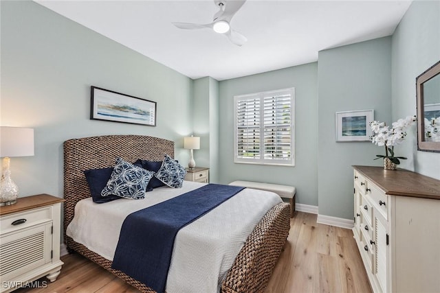 bedroom featuring ceiling fan, light wood-type flooring, and baseboards